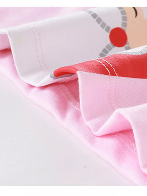 Cozy kids' blush pink cotton pajamas with Santa graphic detail and red trim.