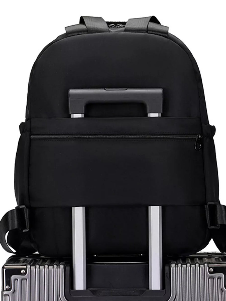 Black Oxford cloth backpack with trolley sleeve and adjustable straps.