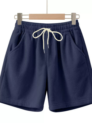 Navy blue corduroy drawstring chino shorts with white tie and elastic waist.
