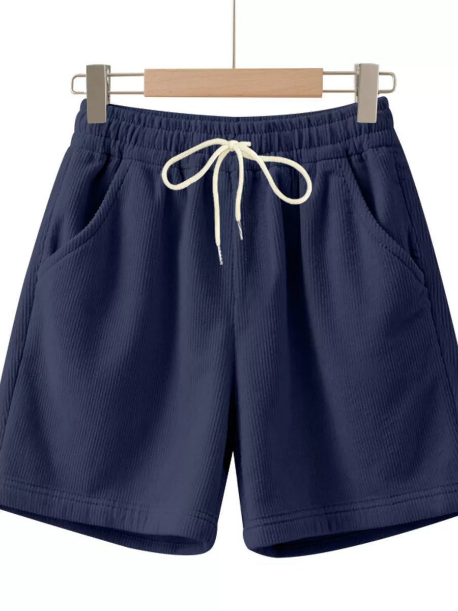 Navy blue corduroy drawstring chino shorts with white tie and elastic waist.