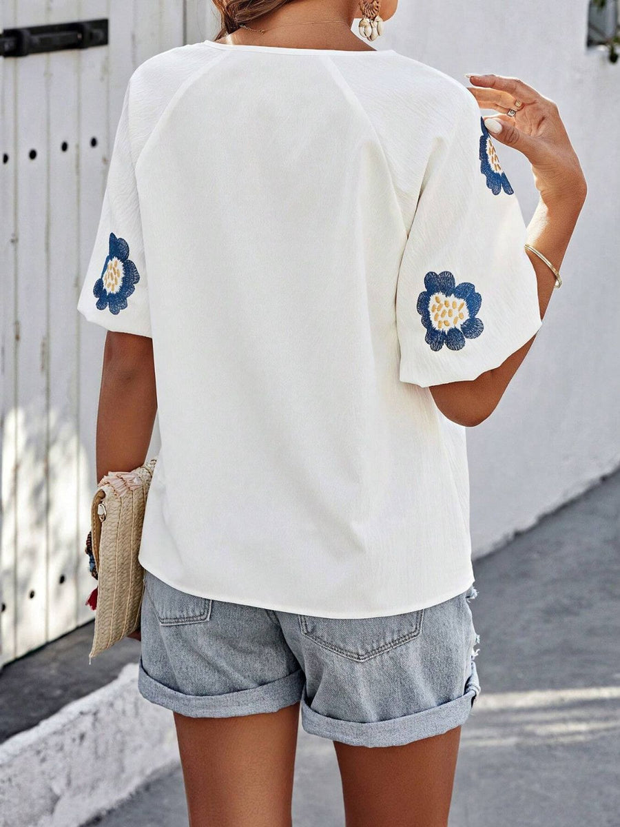 White short sleeve blouse with embroidered blue floral yoke detail