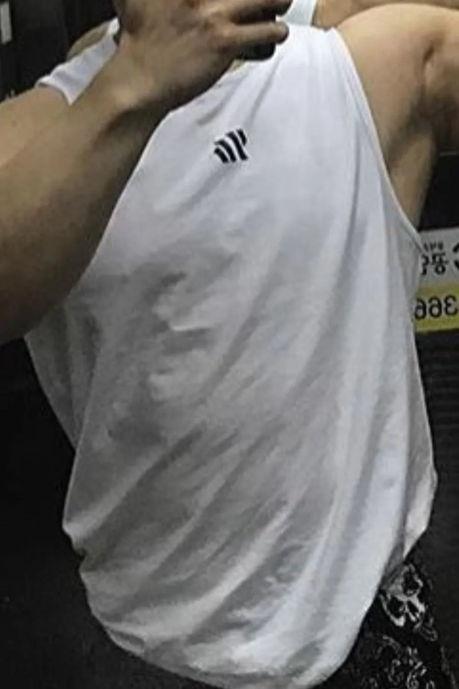 White performance tank top with minimalist logo detail on chest