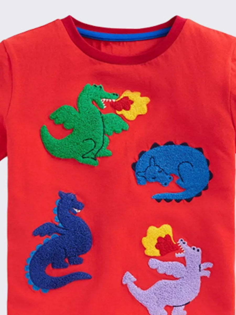 Red cotton t-shirt with multiple dinosaur appliques, including one breathing fire.