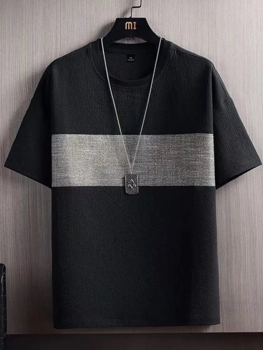 Textured black t-shirt with a gray stripe and round neck