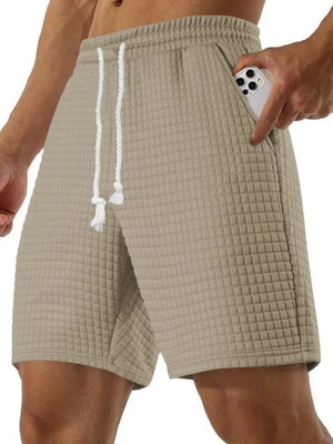 Khaki waffle knit relaxed fit shorts with drawstring and pocket detail.
