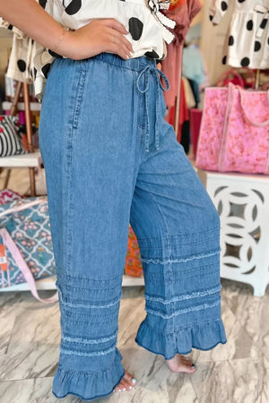 Maternity wide-leg chambray jeans in blue with ruffled hem and drawstring waist.