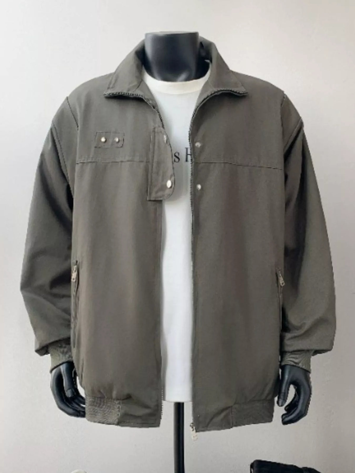 Green casual bomber jacket with zip pockets and buttoned chest detail