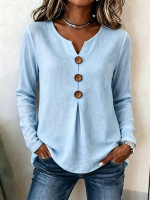 blouse in light blue featuring decorative buttons and relaxed fit