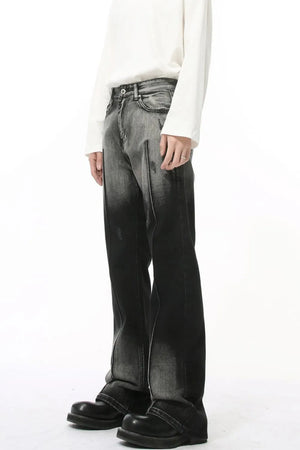 Faded flare jeans in dark wash denim with front pleat detail and distressed accents.