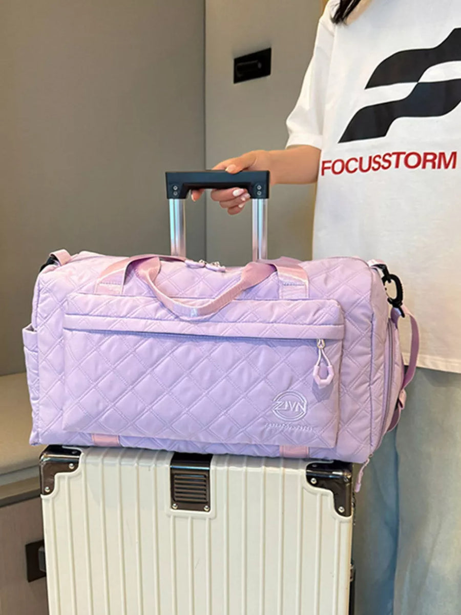 Diamond-quilted travel bag in taro purple with versatile straps and front zipper pocket.
