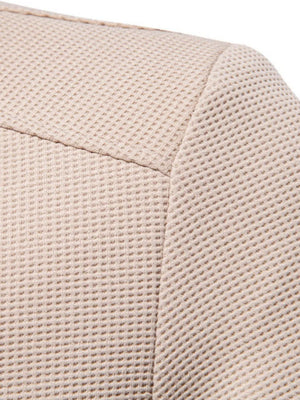 Taupe textured knit bomber jacket detail showing waffle weave fabric and seam.