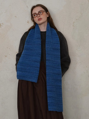 Textured mélange knit scarf in Royal Blue, styled with a dark sweater and brown skirt.