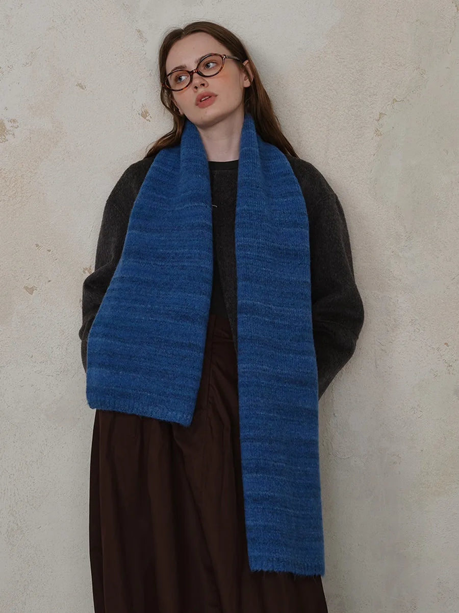 Textured mélange knit scarf in Royal Blue, styled with a dark sweater and brown skirt.
