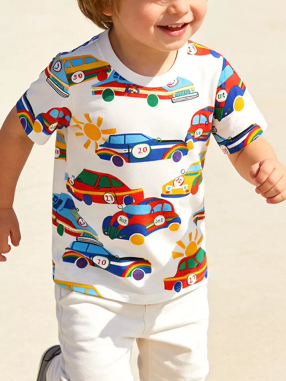 Toddler cotton t-shirt with a playful racing car print and rainbow accents.
