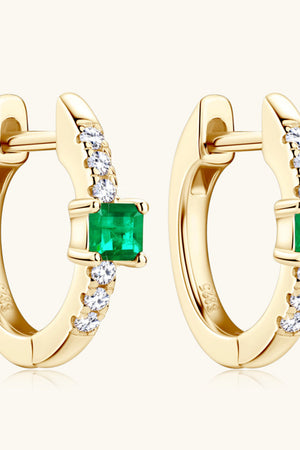 Gold huggie hoop earrings with emerald and pave diamond details