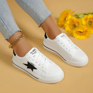 White sneakers with black star patch and black heel detail.