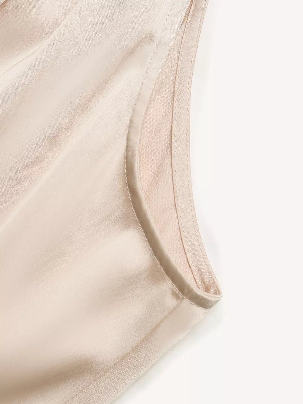 Elegant satin midi dress in champagne with pearl embellishments, showing neckline detail.
