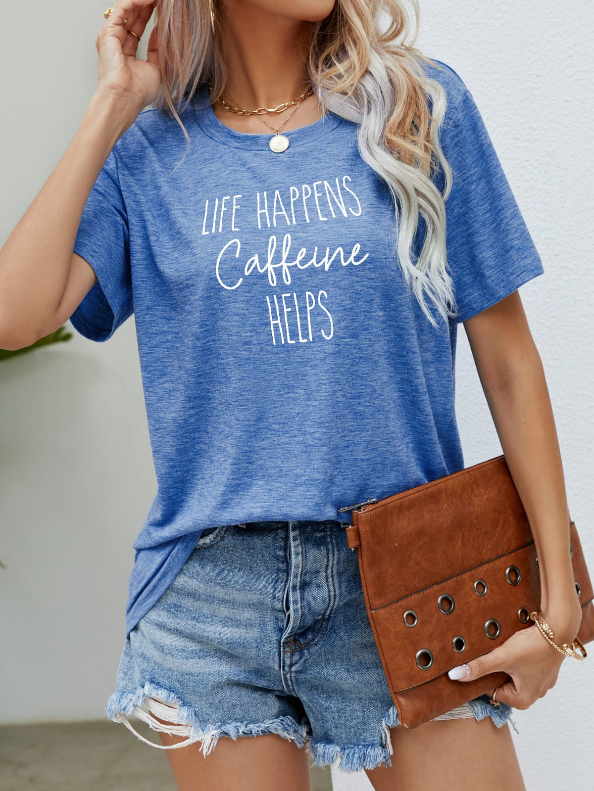 Cobalt blue slub knit t-shirt with "Life Happens Caffeine Helps" graphic print.