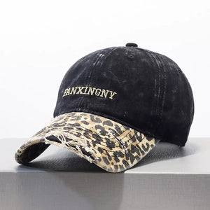 Black distressed baseball hat with leopard print brim and embroidered text
