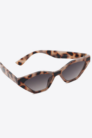 Geometric cat-eye sunglasses with leopard print frames and dark lenses.