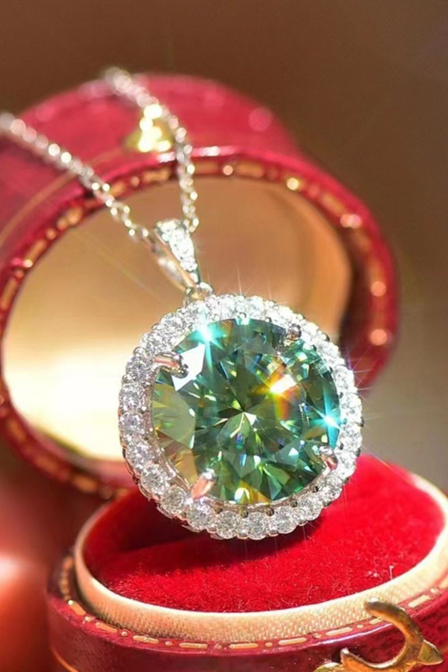 Green moissanite halo necklace in platinum with diamond accents.