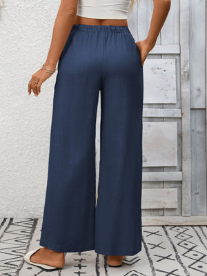 Navy blue high-waist wide-leg pants with drawstring and pockets.