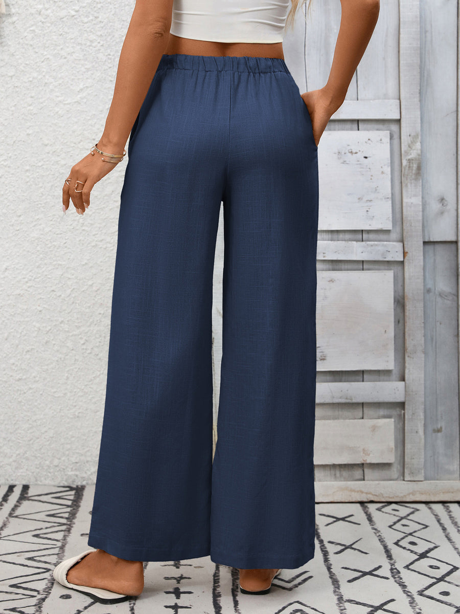 Navy blue high-waist wide-leg pants with drawstring and pockets.