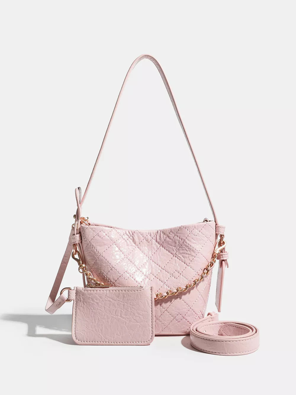 Pink quilted bucket bag with chain accent and matching card holder