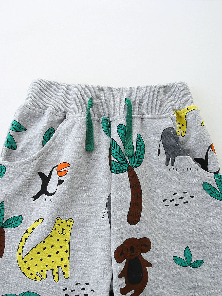 Grey cotton toddler shorts with jungle animal print and green drawstring.