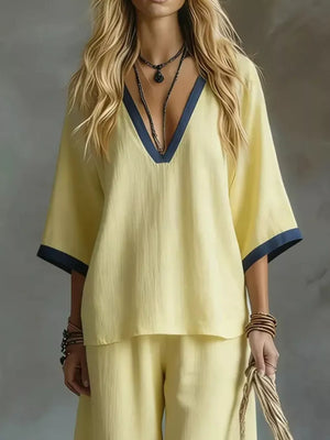 Yellow V-neck two-piece set with contrast trim and wide sleeves.
