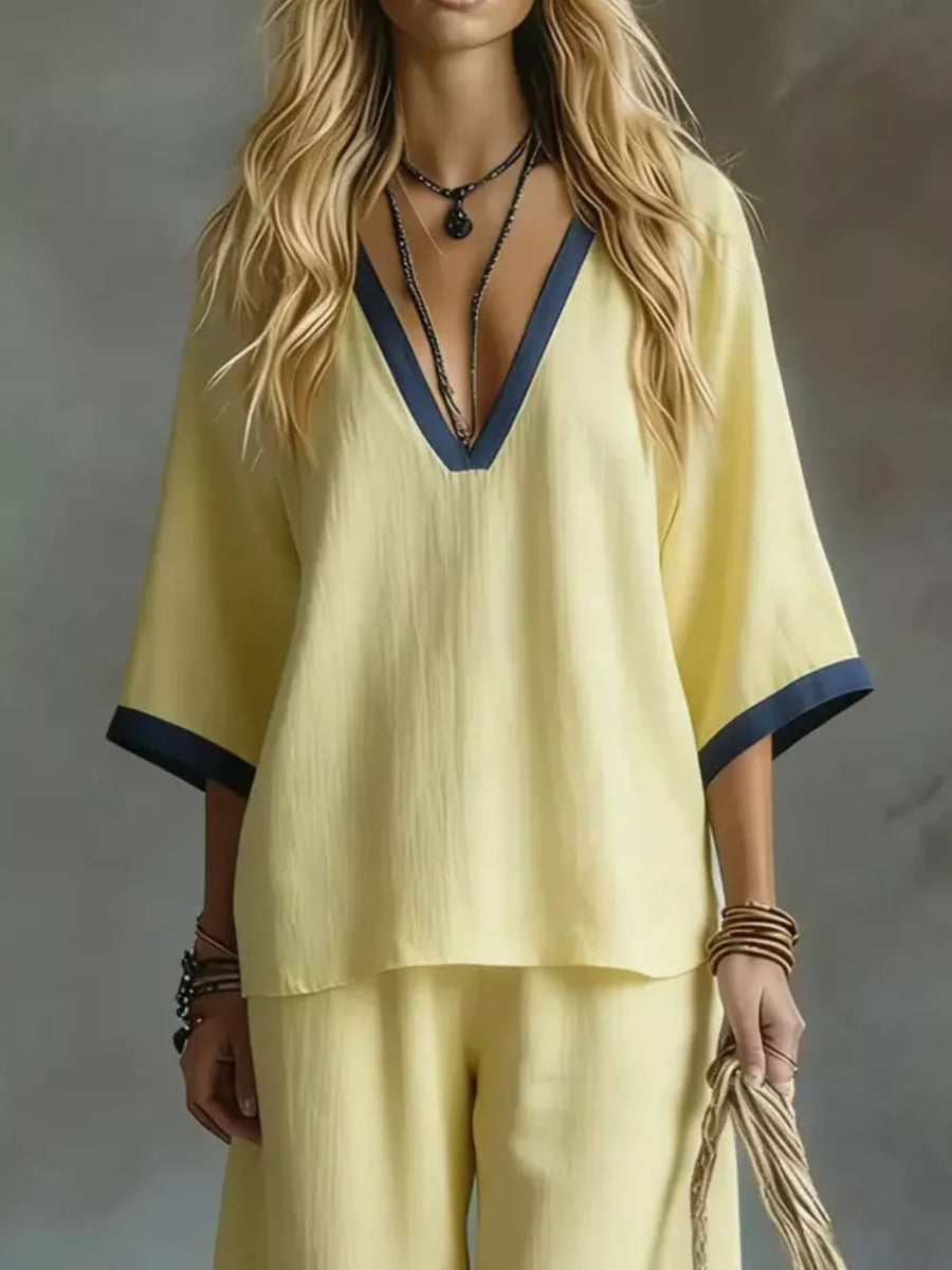 Yellow V-neck two-piece set with contrast trim and wide sleeves.