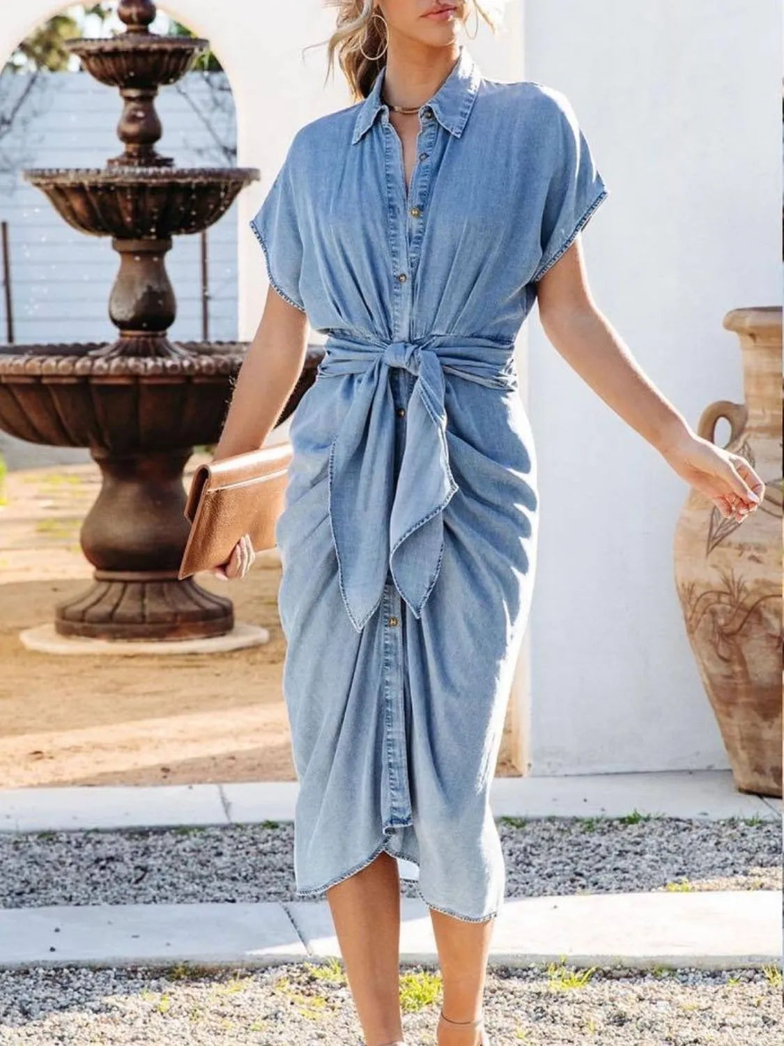 Denim wrap midi shirtdress in medium blue with short sleeves, collared neckline, and tie waist.
