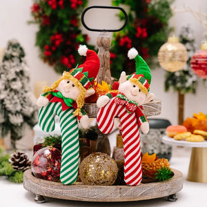 Elf cane holiday ornaments in red and green candy cane stripes with cheerful faces.
