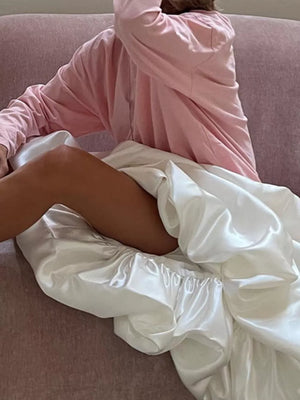 Pink long sleeve top with white satin slip skirt featuring ruched elastic waist