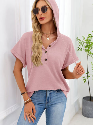 Pink waffle knit short sleeve hooded top with button placket and drawstring detail.