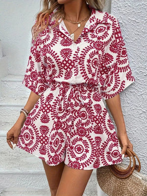 Deep Red printed tie-waist romper with button front and short sleeves.