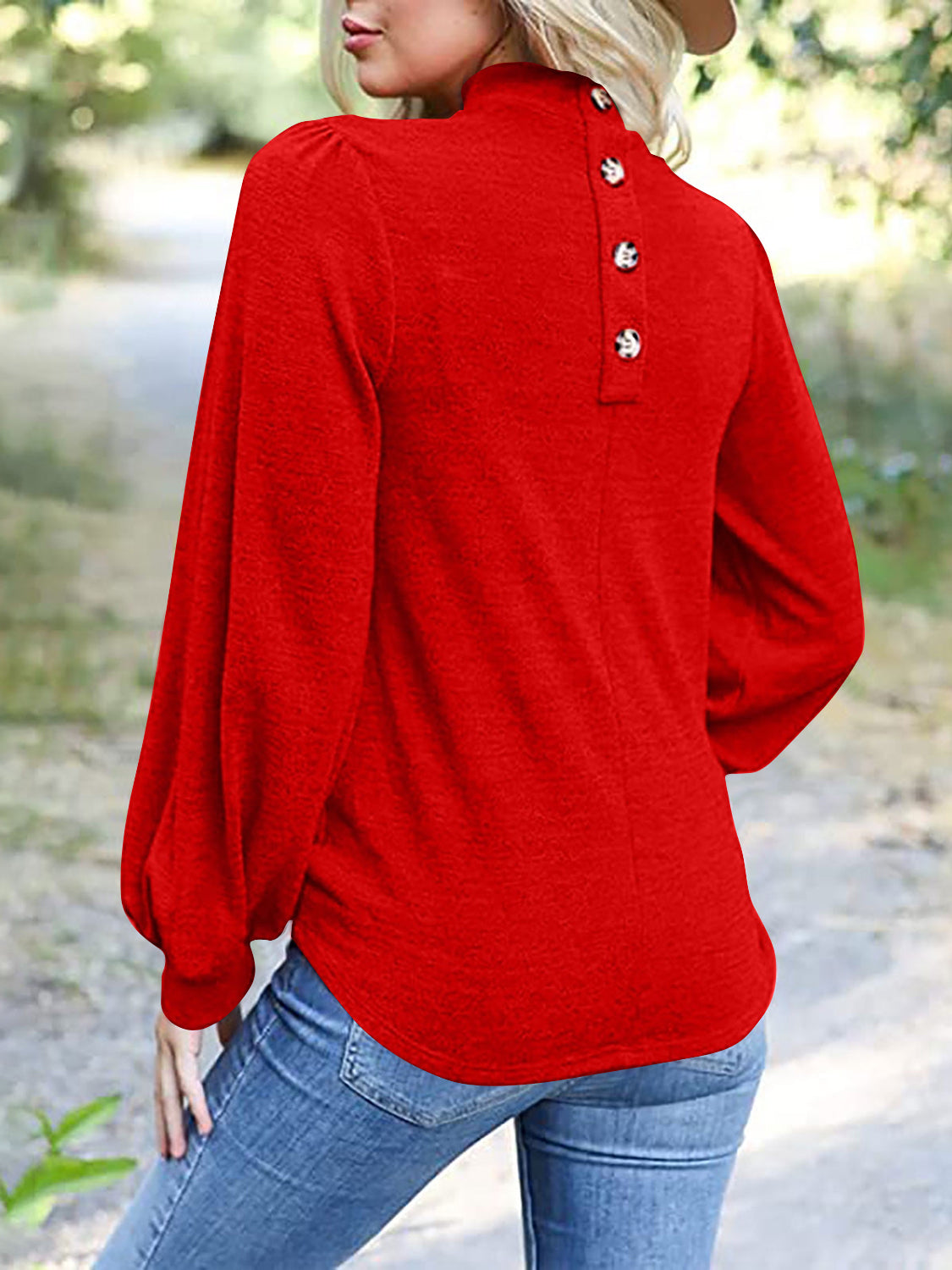 Red puff sleeve mock neck top with button back detail.
