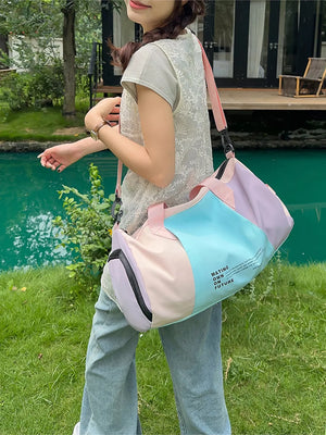 Vibrant pastel nylon duffle bag with color-blocked panels and adjustable strap.