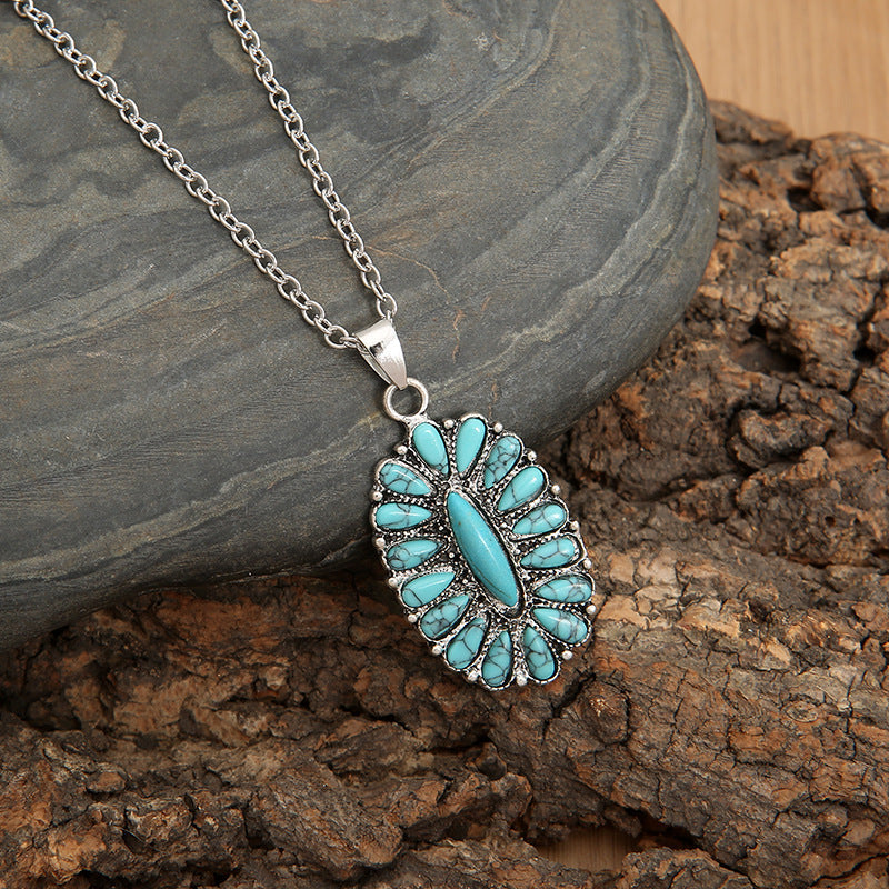 Southwestern turquoise cluster necklace with teal stones and silver chain.