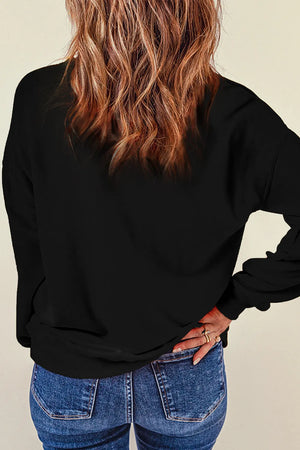 Black crewneck sweatshirt with long sleeves and a relaxed fit, styled with jeans.