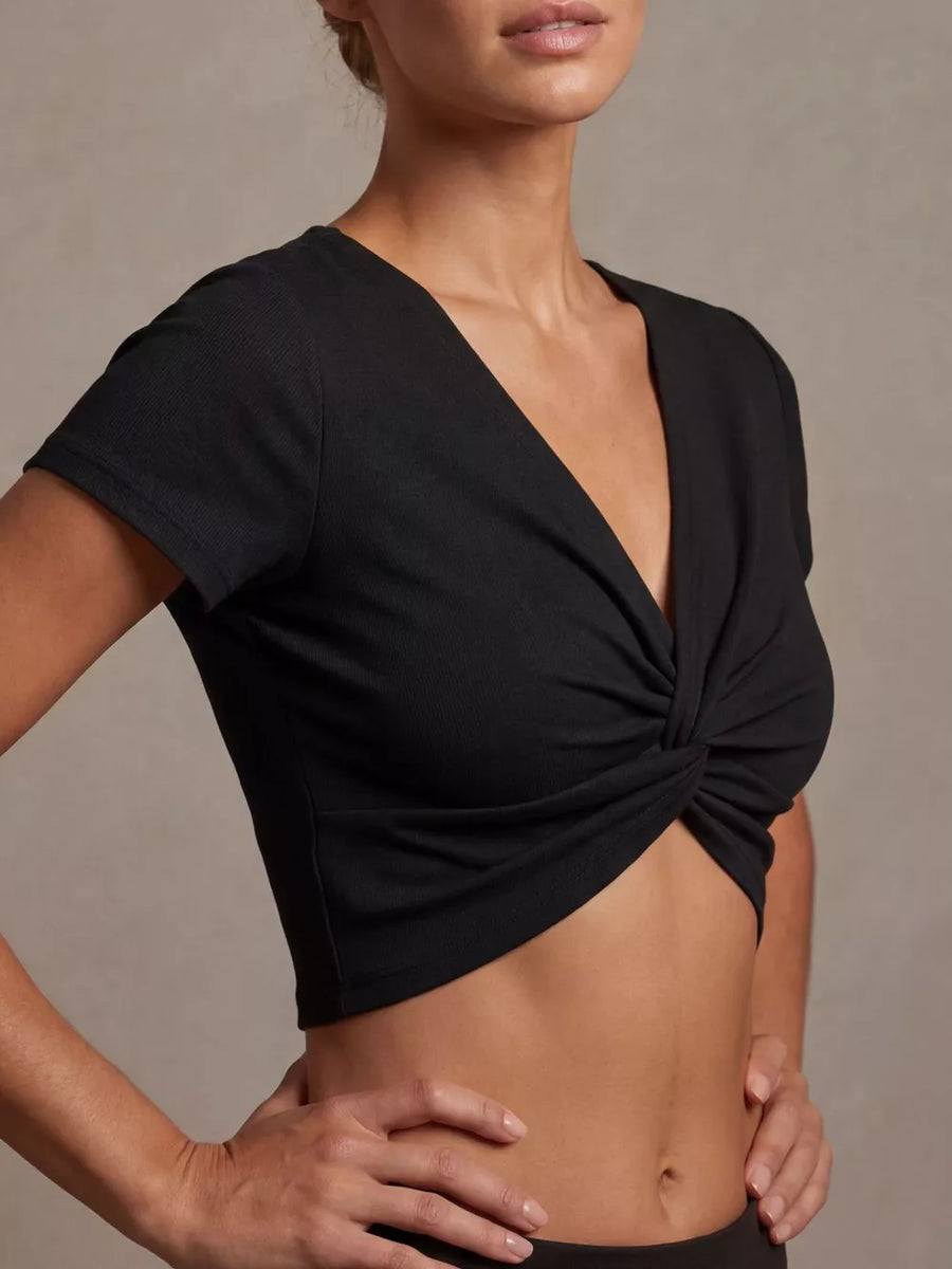 Black ribbed cropped t-shirt with short sleeves and a V-neck twist front detail.
