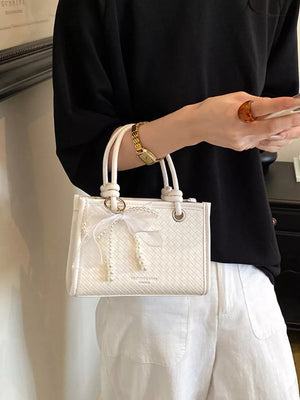crossbody bag in White with geometric and bow embellishment