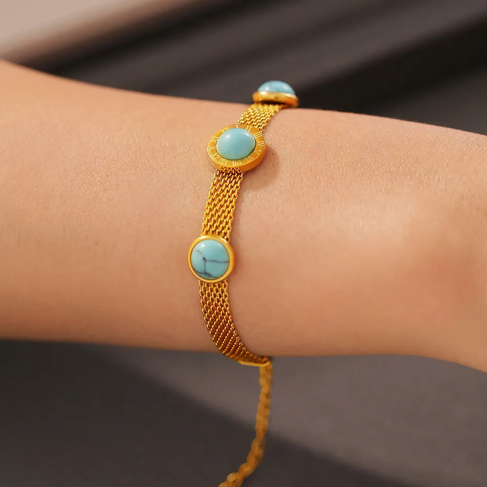 Gold mesh bracelet with turquoise stones and Roman numerals