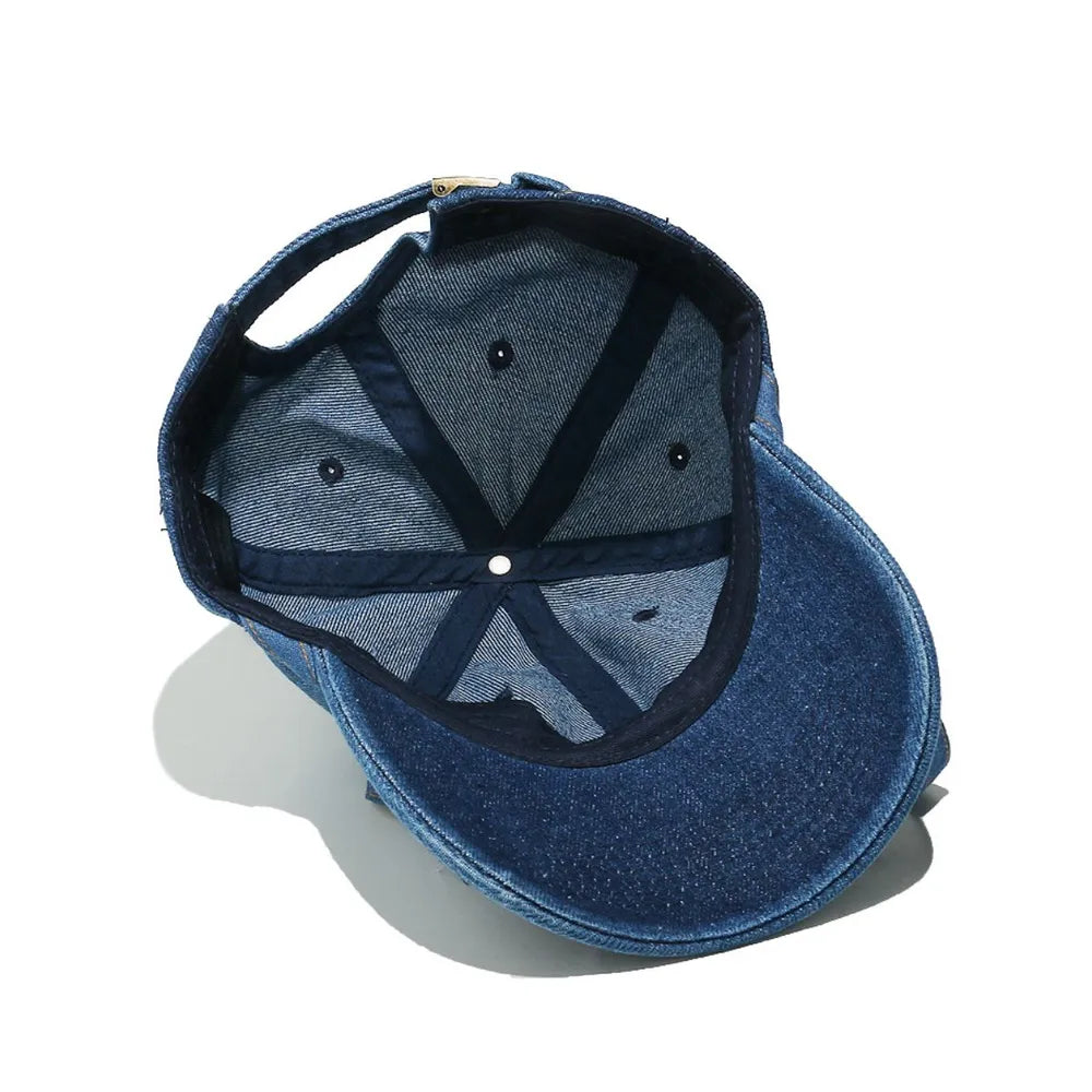 Denim baseball cap in navy showing interior construction and adjustable strap.