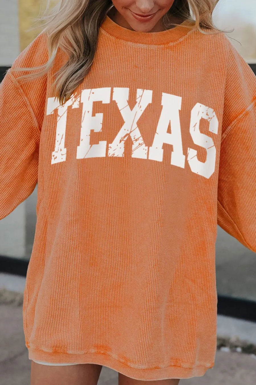 Textured sherbet crewneck sweatshirt with white distressed TEXAS graphic.