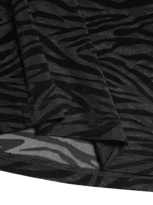 Black sheer zebra-striped mock neck top with long sleeves and a lettuce hem.