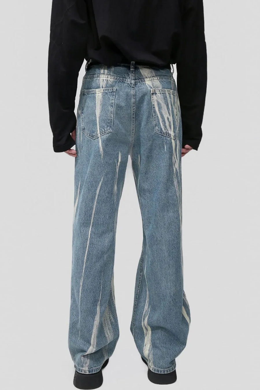 Bleached wash wide leg denim jeans with abstract white paint streaks.