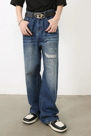Baggy jeans in vintage-wash blue denim with patchwork and distressed details.