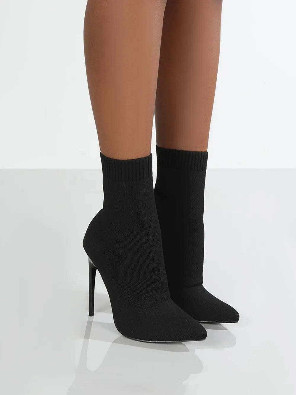Black knit sock booties with pointed toe and stiletto heel