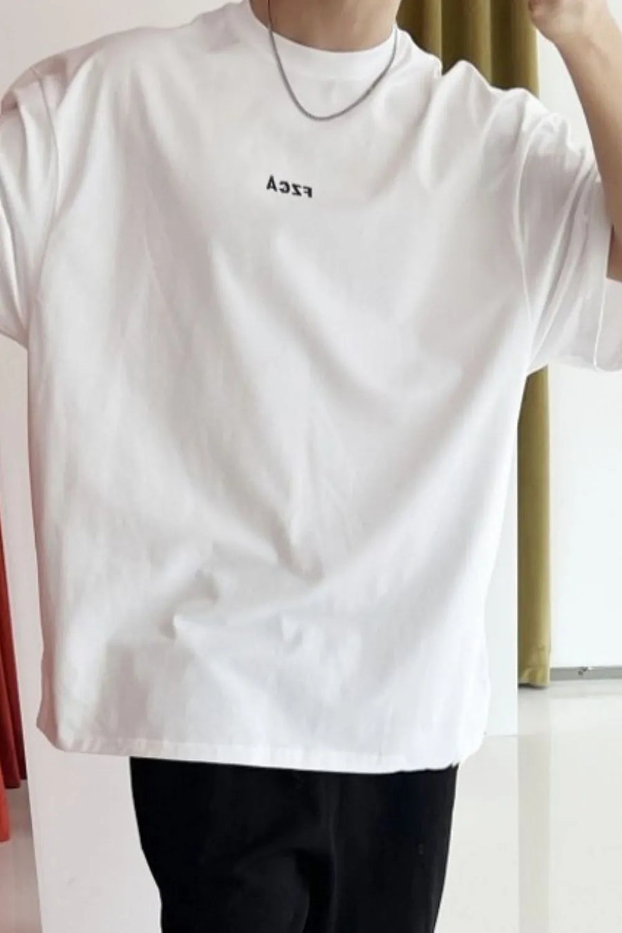 White oversized logo tee with drop shoulder and crew neck.